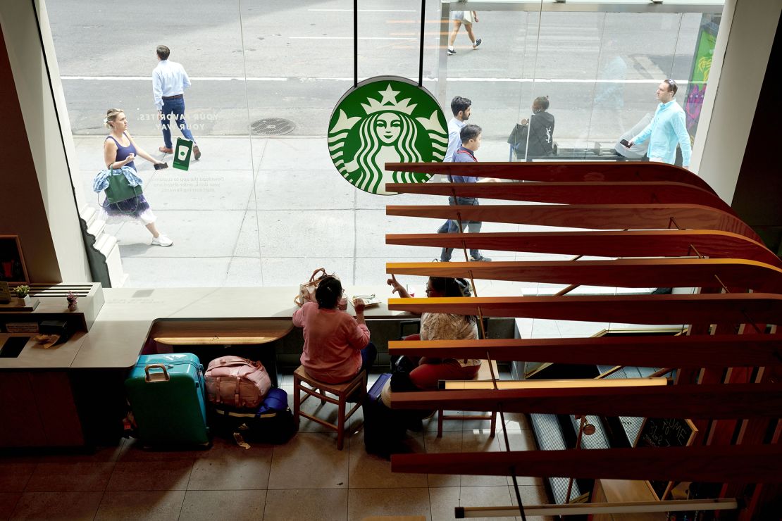 Customers at a Starbucks location in New York, on August 17, 2023. The company is trying to lure back customers looking to sit and enjoy a coffee drink.