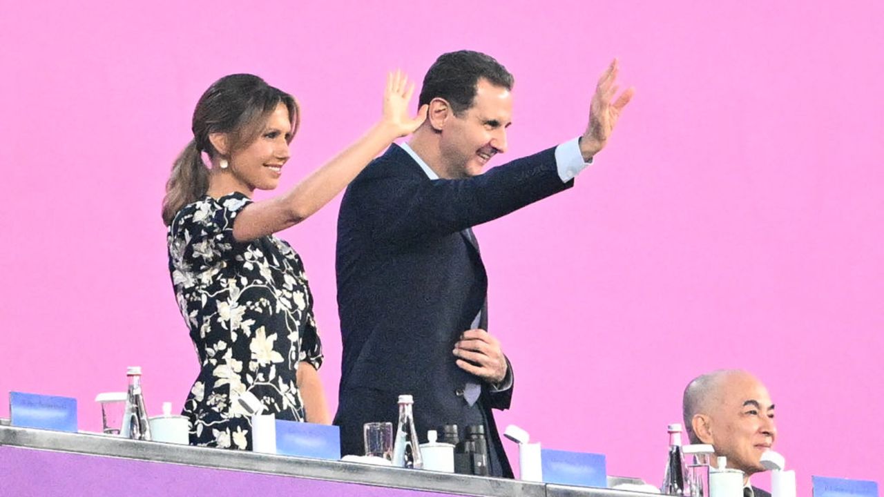 Syria's President Bashar al-Assad (C) and his wife Asma al-Assad (L) attend the opening ceremony of the 2022 Asian Games at the Hangzhou Olympic Sports Centre Stadium in Hangzhou in China's eastern Zhejiang province on September 23, 2023. (Photo by Philip FONG / AFP) (Photo by PHILIP FONG/AFP via Getty Images)