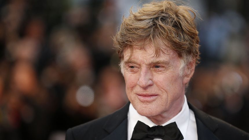 US actor and director Robert Redford poses on May 22, 2013 as he arrives for the screening of the film "All is Lost" presented Out of Competition at the 66th edition of the Cannes Film Festival in Cannes. Cannes, one of the world's top film festivals, opened on May 15 and will climax on May 26 with awards selected by a jury headed this year by Hollywood legend Steven Spielberg.        AFP PHOTO / VALERY HACHE (Photo by Valery HACHE / AFP) (Photo by VALERY HACHE/AFP via Getty Images)