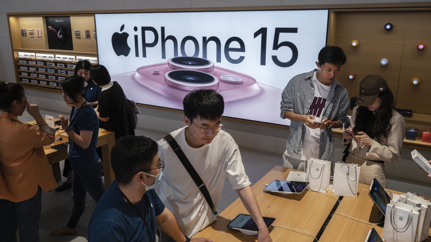 People look at the iPhone 15 and other Apple products at a flagship store in Beijing, China, in September 2023.
