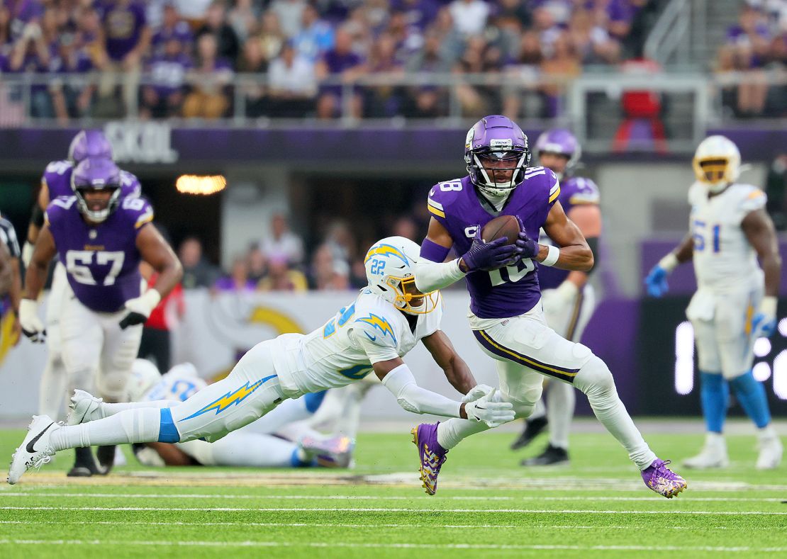 Jefferson runs past JT Woods of the Los Angeles Chargers while scoring a touchdown during a game last season.