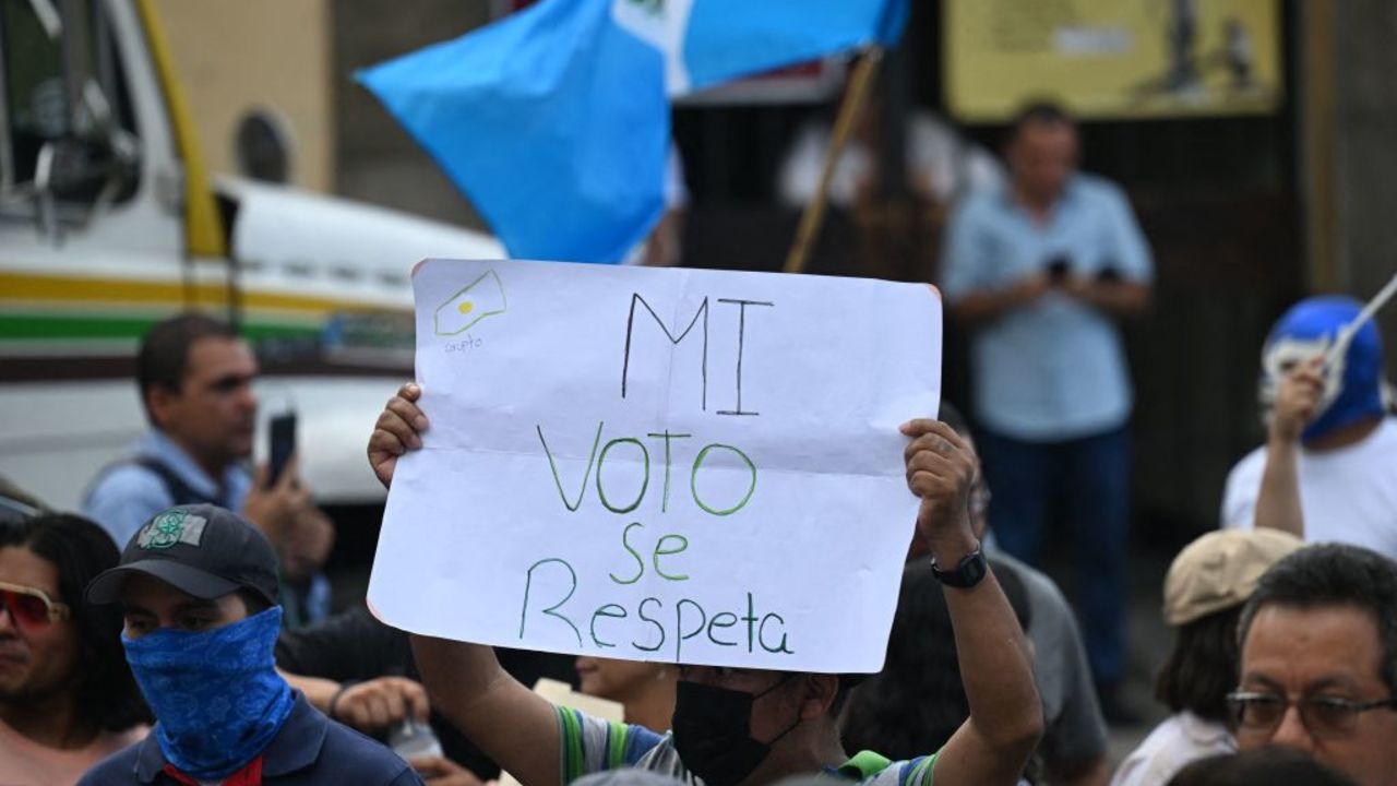 A man holding a sign that reads "My vote must be respected" participates in a protest to demand the resignation of Attorney General Consuelo Porras and prosecutor Rafael Curruchiche, accused of generating an electoral crisis, outside the headquarters of the Supreme Electoral Tribunal in Guatemala City on September 30, 2023. Police from the Guatemala prosecutor's office scuffled Saturday with magistrates in the electoral court while seizing boxes containing tally sheets from this year's presidential election, in a move denounced in foreign capitals. (Photo by Johan ORDONEZ / AFP) (Photo by JOHAN ORDONEZ/AFP via Getty Images)