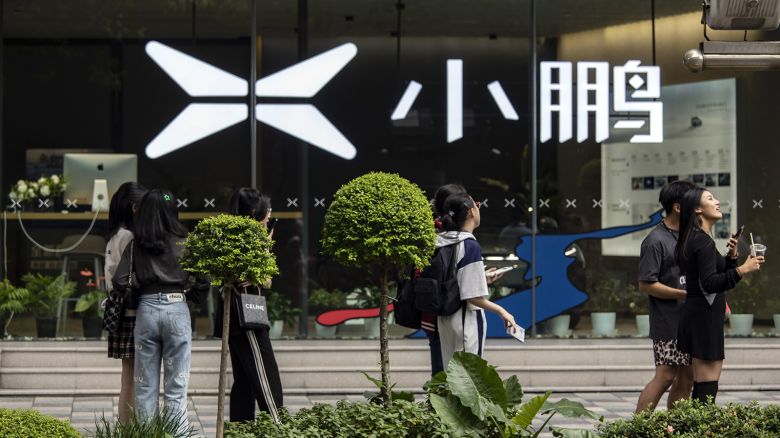 Pedestrians and shoppers pass an XPeng Inc. store on Nanjing Road shopping street in Shanghai.