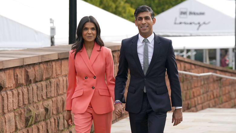 MANCHESTER, ENGLAND - OCTOBER 4: UK Prime Minister Rishi Sunak and his wife Akshata Murty walk to the Main Hall where he will deliver his keynote speech during day four of the Conservative Party Conference on October 4, 2023 in Manchester, England. Rishi Sunak delivers his first speech as Conservative Party Leader to members and delegates today. He is expected to announce the scrapping of the Manchester leg of the HS2 rail link and suggests alternatives.  (Photo by Ian Forsyth/Getty Images)