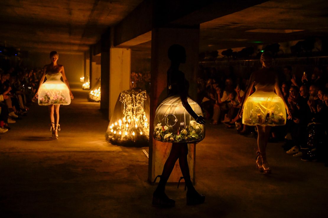 Eerily romantic terrarium dresses featuring live butterflies at the Undercover show —  a standout moment of fashion innovation.