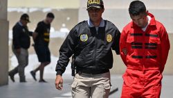 Peruvian police carry out the transfer of several members of the Tren de Aragua criminal organization in Lima on October 5, 2023. Peruvian police on Thursday captured the alleged leader and 31 other members of a faction of the Tren de Aragua, the Venezuelan-born criminal organization that sows terror in several South American countries with murders and extortion, according to authorities. The offensive against what is considered the most dangerous gang operating in Peru was carried out in several regions of the country. (Photo by Cris BOURONCLE / AFP) (Photo by CRIS BOURONCLE/AFP via Getty Images)