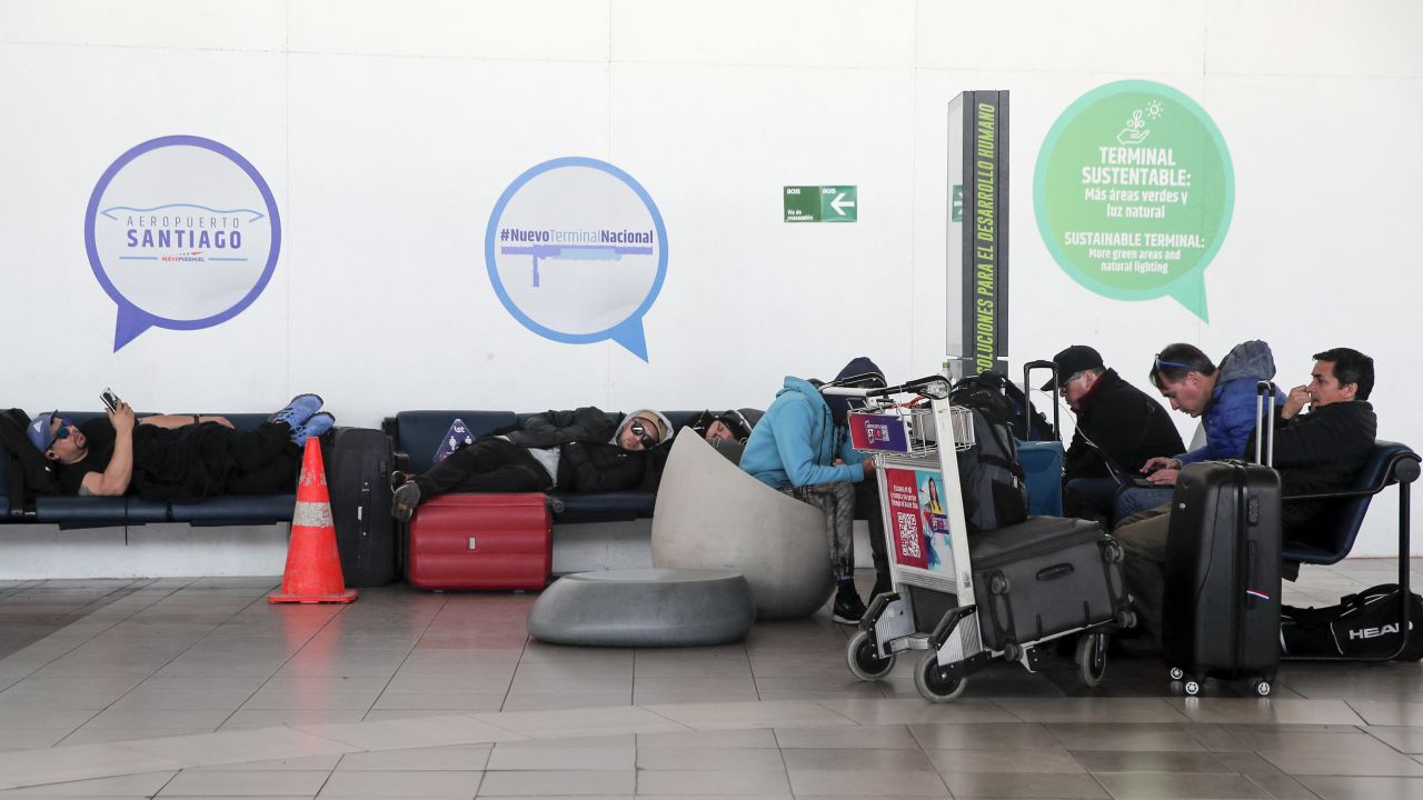 Passengers wait at Arturo Merino Benitez International Airport in Santiago, on October 6, 2023, during a strike by air traffic controllers. A strike by air traffic controllers in Chile, who are demanding better safety measures and job improvements, caused delays and the suspension of domestic flights at Santiago airport on Friday. The protest was called by the Chilean Air Traffic Controllers Association and in the early hours of Friday had led to the cancellation of at least 12 flights of the Latam airline, the largest in Latin America in terms of routes and fleet. (Photo by Javier TORRES / AFP) (Photo by JAVIER TORRES/AFP via Getty Images)