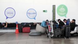 Passengers wait at Arturo Merino Benitez International Airport in Santiago, on October 6, 2023, during a strike by air traffic controllers. A strike by air traffic controllers in Chile, who are demanding better safety measures and job improvements, caused delays and the suspension of domestic flights at Santiago airport on Friday. The protest was called by the Chilean Air Traffic Controllers Association and in the early hours of Friday had led to the cancellation of at least 12 flights of the Latam airline, the largest in Latin America in terms of routes and fleet. (Photo by Javier TORRES / AFP) (Photo by JAVIER TORRES/AFP via Getty Images)