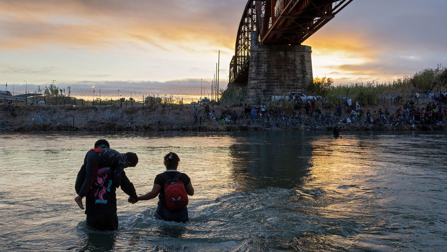 A family wades through the Rio Grande while crossing from Mexico into the United States on September 30 in Eagle Pass, Texas.