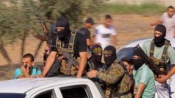 Palestinian militants move towards the border fence with Israel from Khan Younis in the southern Gaza Strip on October 7, 2023.