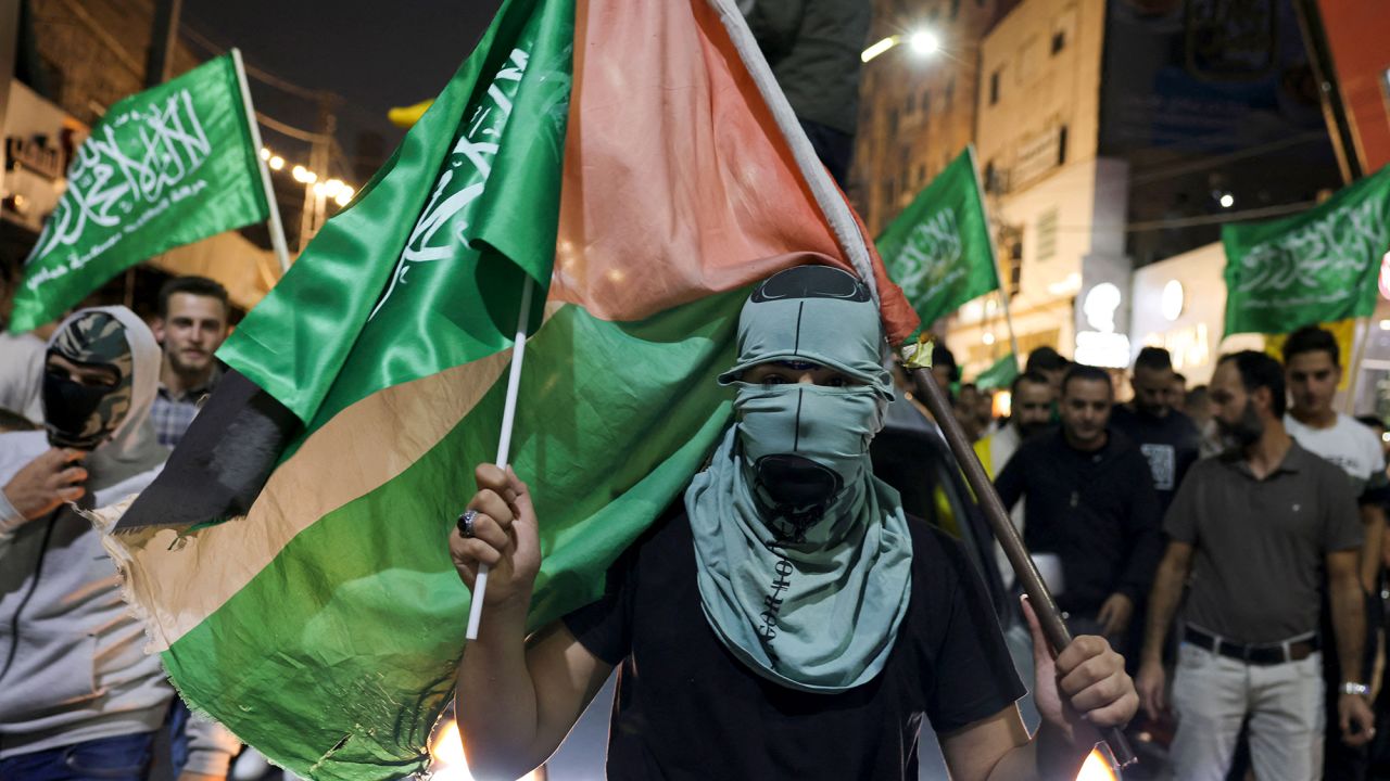 Supporters of the Fatah and Hamas movments lift group and Palestinian flags as they march in Hebron city in the occupied West Bank on October 11, 2023, to protest the Israeli bombardment of the Gaza Strip. Israel kept up its bombardment of Hamas targets in the Gaza Strip on October 11, as Prime Minister Benjamin Netanyahu and a political rival announced an emergency government for the duration of the conflict that has killed thousands. (Photo by HAZEM BADER / AFP) (Photo by HAZEM BADER/AFP via Getty Images)