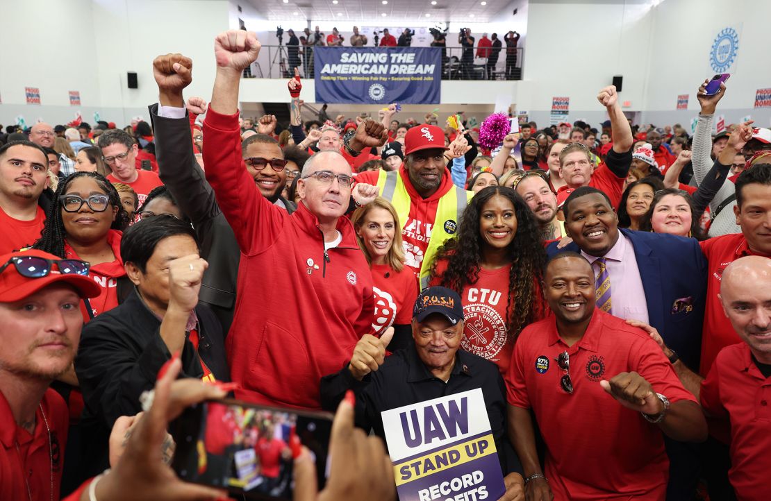 UAW President Shawn Fain, center left, stands for pictures with the Rev. Jesse Jackson, bottom center, after a rally for striking workers in Chicago last month.
