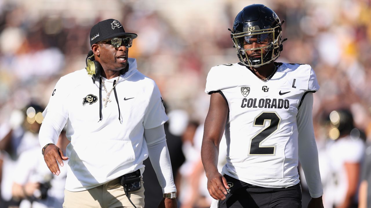 TEMPE, ARIZONA - OCTOBER 07: Head coach Deion Sanders of the Colorado Buffaloes talks with quarterback Shedeur Sanders #2 during first half of the NCAAF game against the Arizona State Sun Devils at Mountain America Stadium on October 07, 2023 in Tempe, Arizona. (Photo by Christian Petersen/Getty Images)