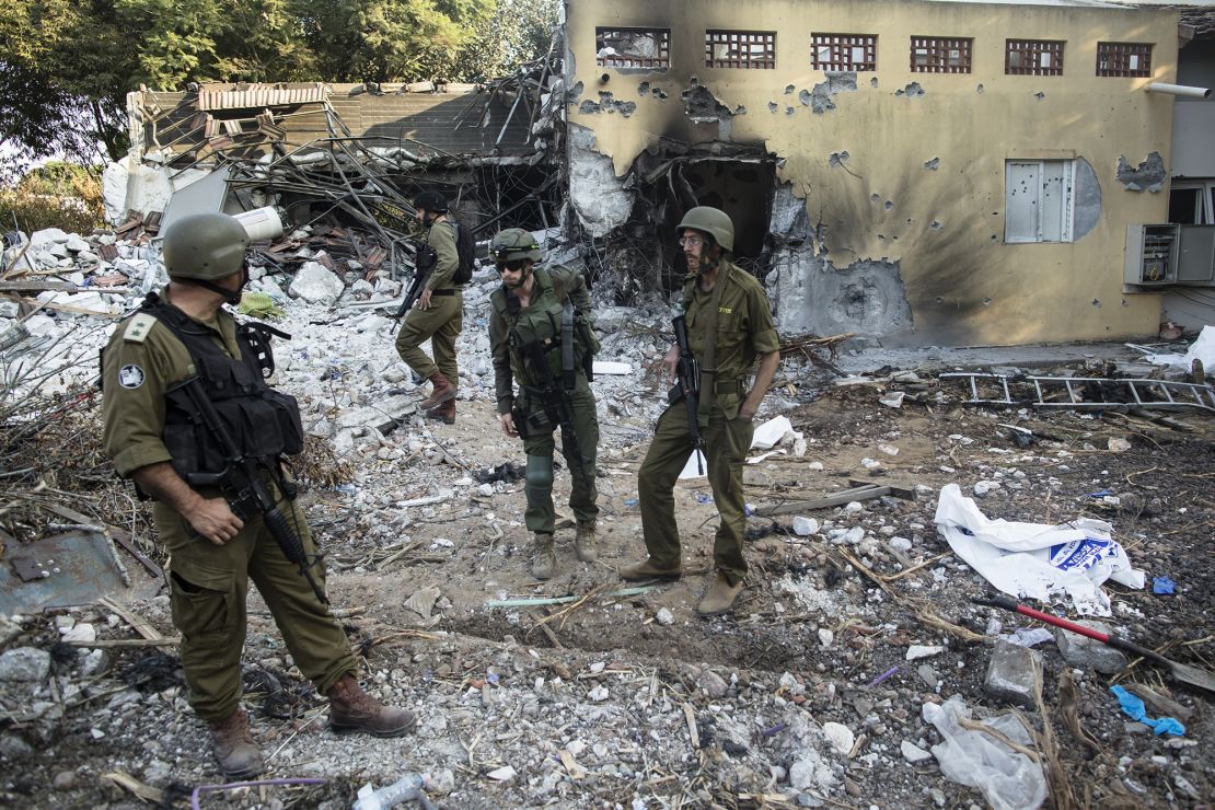 Israeli soldiers inspect houses that were destroyed in a battle between Israeli soldiers and Palestinian militants on Saturday's Hamas attack on a kibbutz in Be'eri, Israel, on October 14.