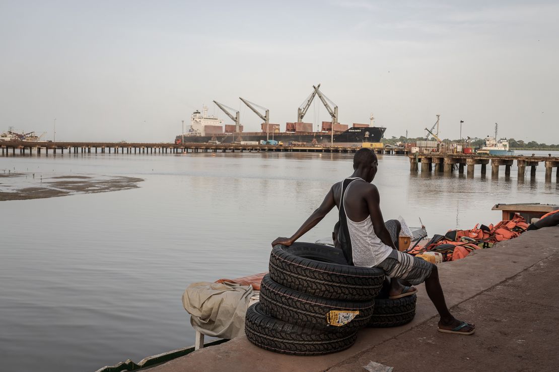 A local man is seen sitting at the port of Bissau as daily life continues in Bissau, the capital of Guinea-Bissau, on October 5, 2023.