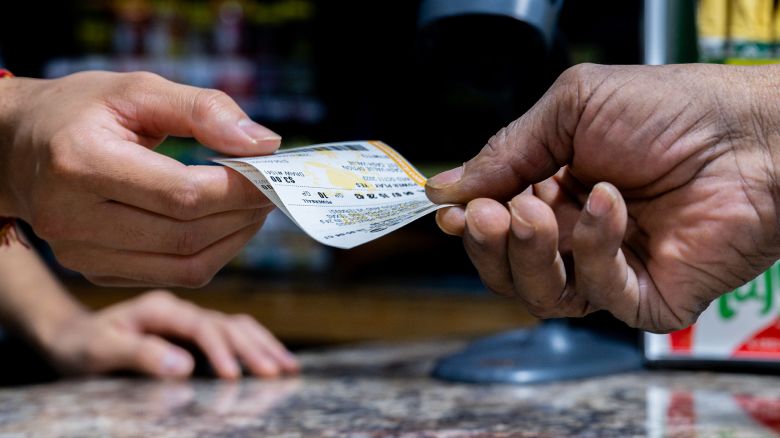 A customer purchases a Powerball lottery ticket at the Brew Market & Cafe on October 10, 2023 in Austin, Texas.
