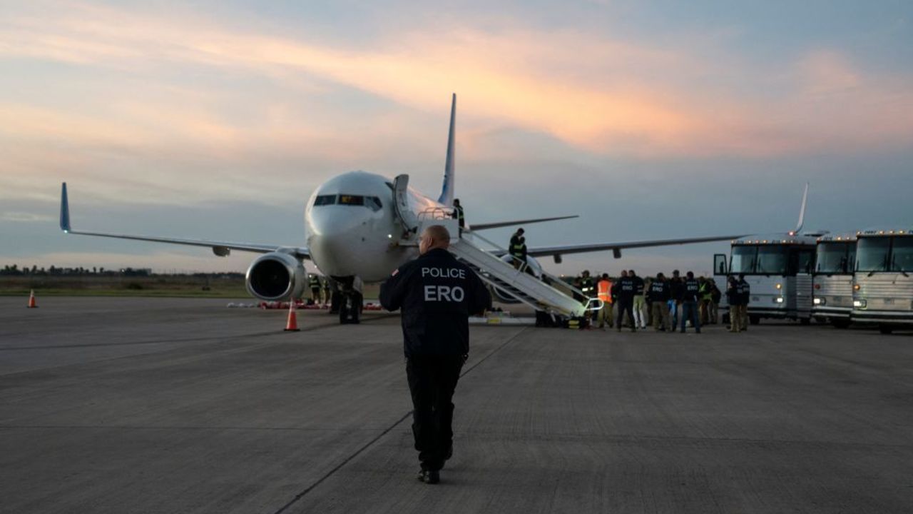 An Enforcement and Removal Operations (ERO) police walks towards the first deportation flight of undocumented Venezuelans after a US-Venezuelan agreement in Harlingen, Texas, on October 18, 2023. The United States said on October 5, 2023 it will resume deportation flights to Venezuela after a deal with Caracas, as President Joe Biden, seeking reelection, comes under pressure to halt border crossings. Washington has for years halted sending migrants back to Venezuela due to instability in the South American nation and still maintains sanctions against the government of President Nicolas Maduro. (Photo by VERONICA G. CARDENAS / AFP) (Photo by VERONICA G. CARDENAS/AFP via Getty Images)