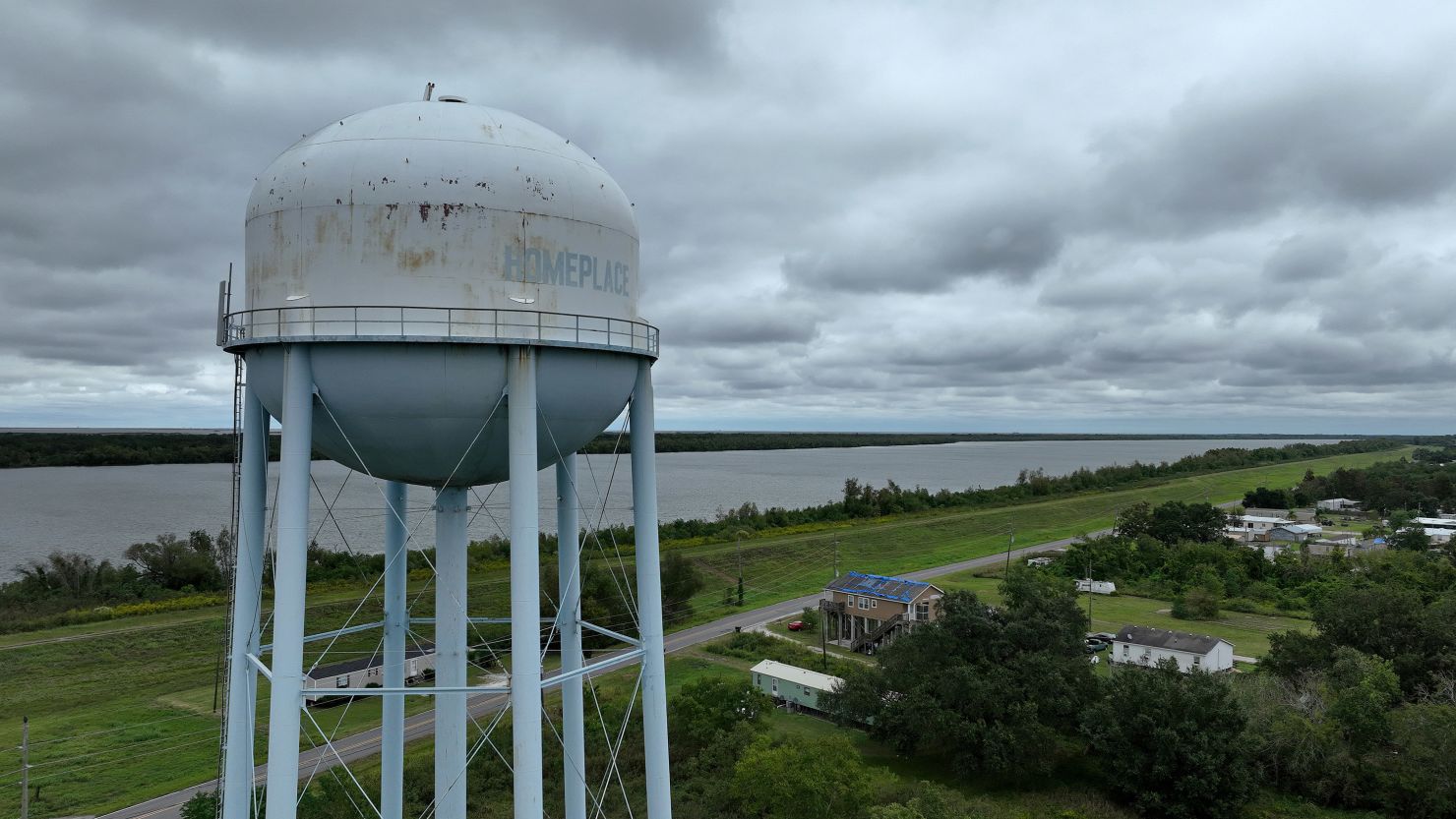 PORT SULPHUR, LOUISIANA - OCTOBER 12: In an aerial view, a water tower stands over homes along the banks of the Mississippi River on October 12, 2023 in Port Sulphur, Louisiana. As a saltwater intrusion from the Gulf of Mexico continues to push its way up the drought-stricken Mississippi River towards New Orleans, the U.S. Army Corps of Engineers are using pipes to move dredged silt to fortify an underwater sill along the bottom of the Mississippi River that should slow the movement of the saltwater wedge. The U.S. Army Corps of Engineers started barging fresh water to water treatment facilities in Plaquemines Parish to help dilute the salinity content to levels safe for water treatment. If the saltwater intrusion isn't slowed it could find its way upriver to the New Orleans area by the end of October, threatening fresh drinking water for residents. (Photo by Justin Sullivan/Getty Images)