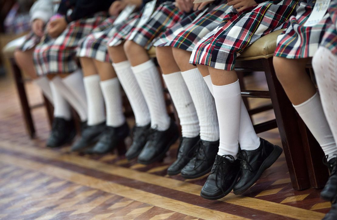 Students in uniform in Puebla, Mexico with matching skirts, socks and shoes.