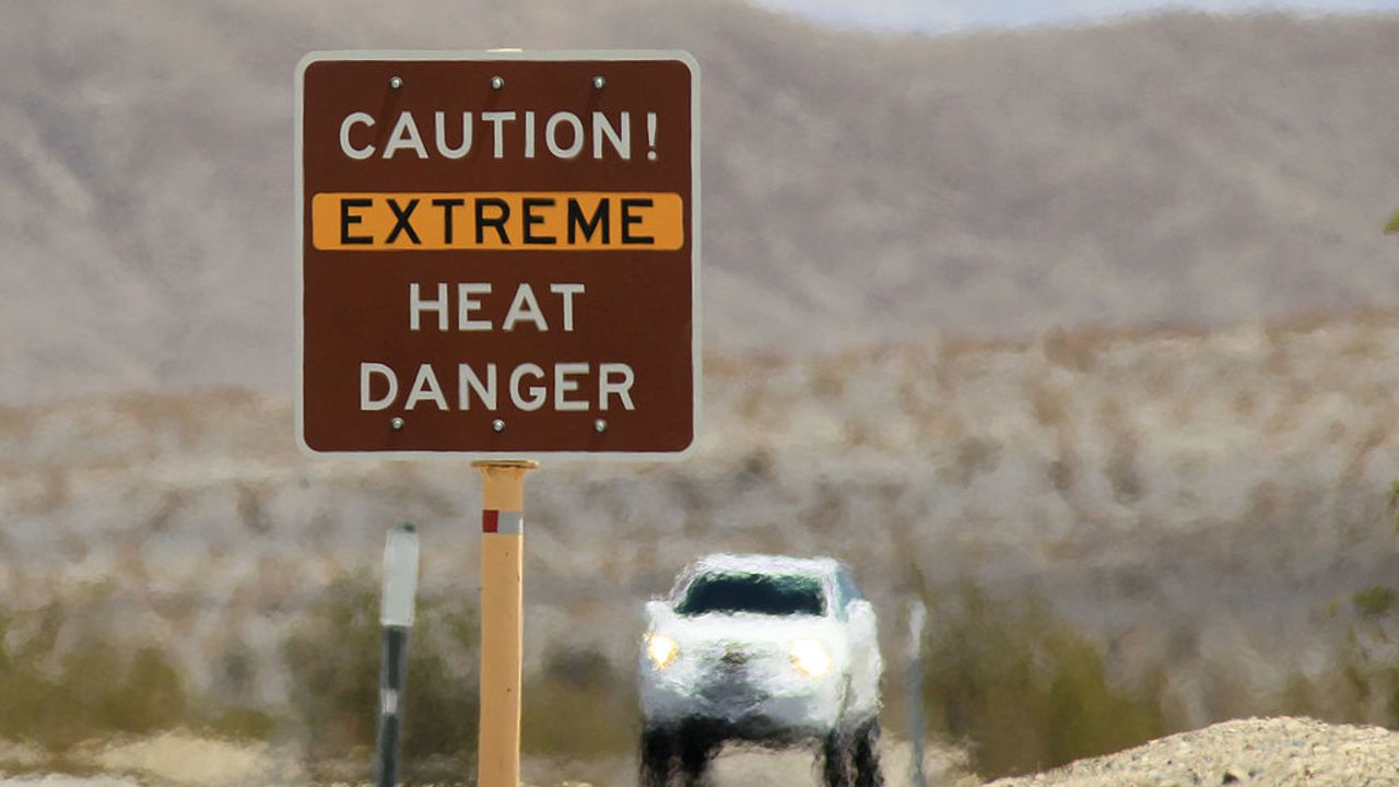 DEATH VALLEY NATIONAL PARK, CA JULY 14:  Heat waves rise near a heat danger warning sign on the eve of the AdventurCORPS Badwater 135 ultra-marathon race on July 14, 2013 in Death Valley National Park, California. Billed as the toughest footrace in the world, the 36th annual Badwater 135 starts at Badwater Basin in Death Valley, 280 feet below sea level, where athletes begin a 135-mile non-stop run over three mountain ranges in extreme mid-summer desert heat to finish at 8,350-foot near Mount Whitney for a total cumulative vertical ascent of 13,000 feet. July 10 marked the 100-year anniversary of the all-time hottest world record temperature of 134 degrees, set in Death Valley where the average high in July is 116. A total of 96 competitors from 22 nations are attempting the run which equals about five back-to-back marathons. Previous winners have completed all 135 miles in slightly less than 24 hours.  (Photo by David McNew/Getty Images)