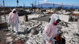 LAHAINA, HAWAII - OCTOBER 09: Volunteers from Samaritan's Purse help a daughter search for family items in the rubble of her mother's wildfire destroyed home on October 09, 2023 in Lahaina, Hawaii. Volunteers from Samaritan's Purse helped displaced residents and family members search for meaningful personal belongings at several destroyed homes in the area. The wind-whipped wildfire on August 8th killed at least 98 people while displacing thousands more and destroying over 2,000 buildings in the historic town, most of which were homes. A phased reopening of tourist resort areas in west Maui began October 8th on the two-month anniversary of the deadliest wildfire in modern U.S. history.  (Photo by Mario Tama/Getty Images)