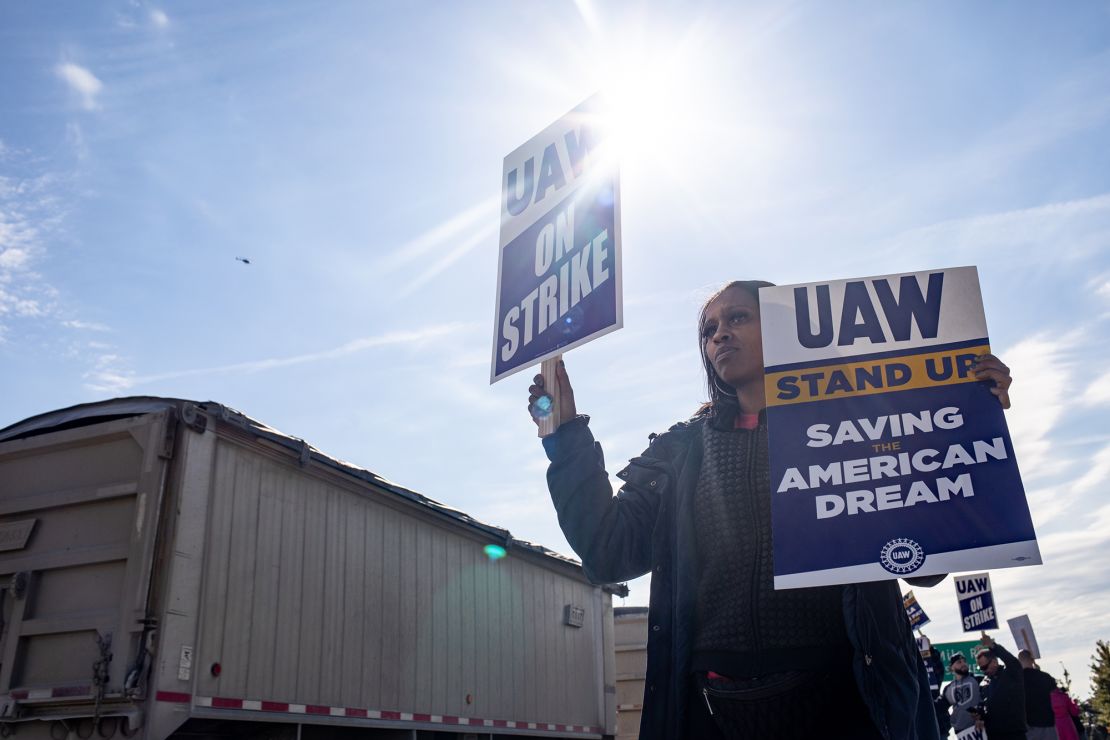 A UAW On Strike sign held on a picket line outside the Stellantis Assembly Plant in Sterling Heights, Michigan, shortly before the end of the strike.