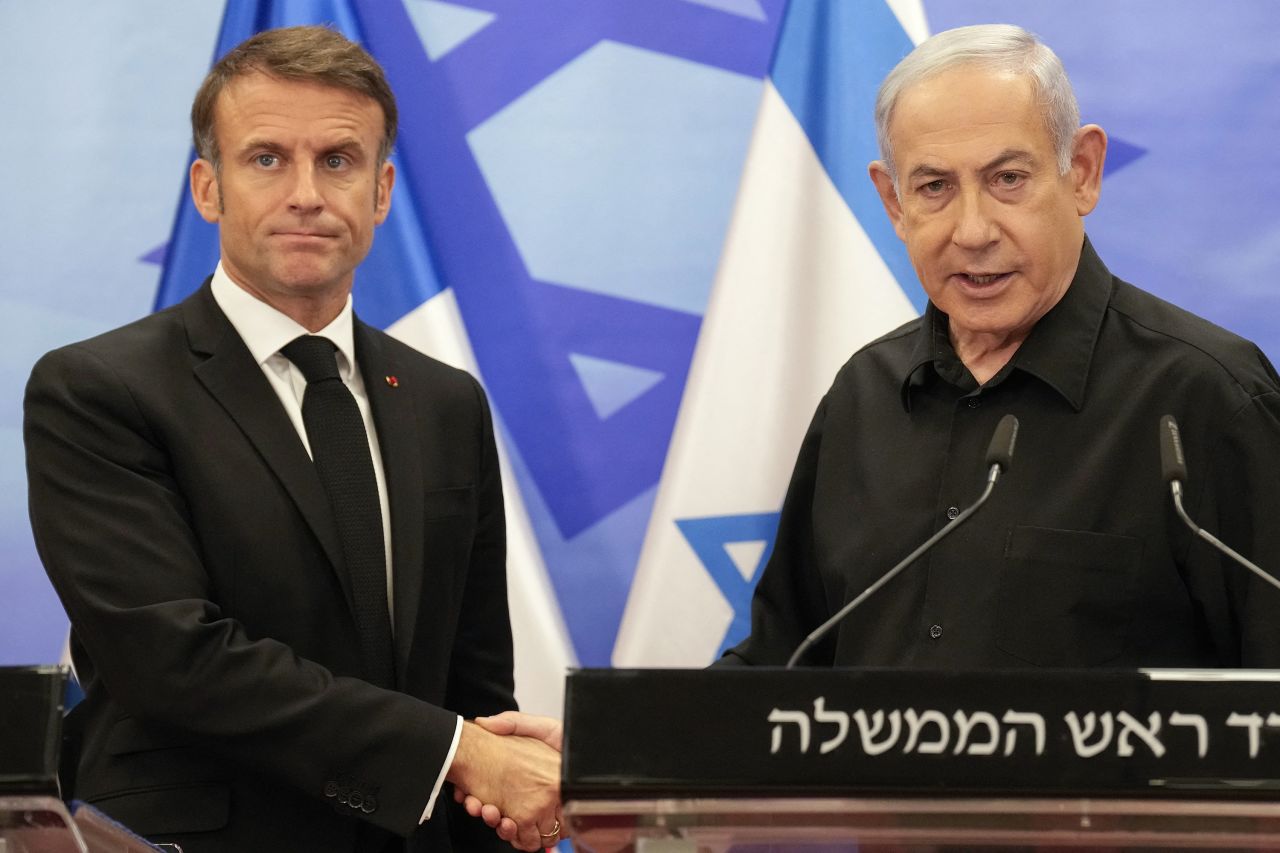 TOPSHOT - Israeli Prime Minister Benjamin Netanyahu (R) shakes hands with French President Emmanuel Macron (L) after their joint press conference in Jerusalem on October 24, 2023. Macron's visit comes more than two weeks after Hamas militants stormed into Israel from the Gaza Strip and killed at least 1,400 people, according to Israeli officials while Israel continues a relentless bombardment of the Gaza Strip and prepares for a ground offensive with more than 5,000 Palestinians, mainly civilians, killed so far across the Palestinian territory, according to the latest toll from the Hamas health ministry in Gaza. (Photo by Christophe Ena / POOL / AFP) (Photo by CHRISTOPHE ENA/POOL/AFP via Getty Images)