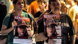 A woman and a man hold placards identifying one of the Israeli hostages Liri Albag held by Palestinian militants since the October 7 attack, during a demonstration in solidarity with them in the centre of Tel Aviv on October 24, 2023. Fighting has entered its 18th day in the Gaza Strip after Hamas gunmen stormed into Israel on October 7, killing at least 1,400 people and taking over 200 hostages, according to Israeli officials. (Photo by AHMAD GHARABLI / AFP) (Photo by AHMAD GHARABLI/AFP via Getty Images)