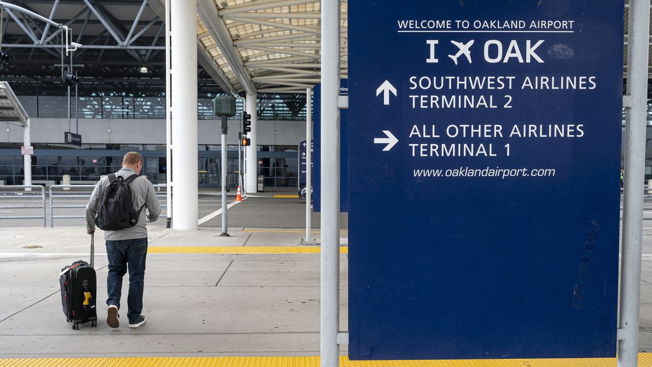 A traveler walks towards a Southwest Airlines check-in area at the Oakland International Airport in Oakland, California, US, on Tuesday, Sept. 19, 2023. Southwest Airlines Co. is scheduled to release earnings figures on October 26. Photographer: David Paul Morris/Bloomberg via Getty Images