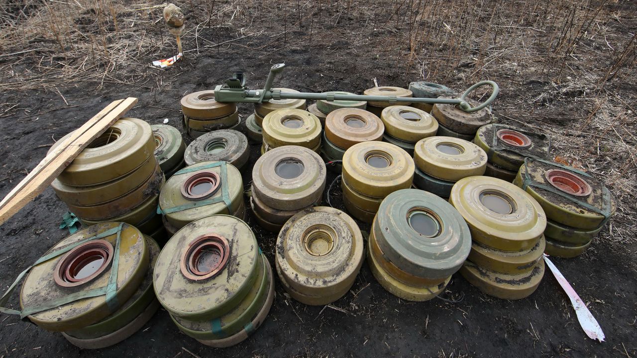 Anti-tank mines found by a consolidated squad of the Explosives Service of Ukraine are stacked on the ground during demining works in Kharkiv Region, northeastern Ukraine.