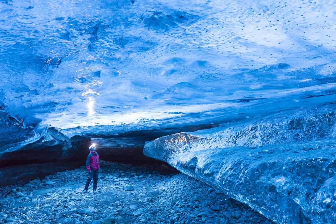 A tourist at a natural ice cave in the Breiðamerkurjökull Glacier in Vatnajökull National Park, Iceland. An American tourist lost his life in an ice cave in August.