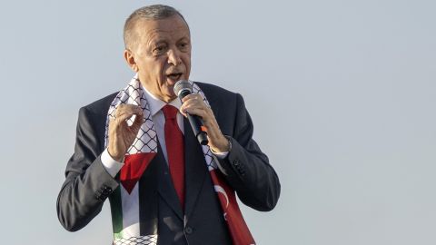 TOPSHOT - Turkish President Recep Tayyip Erdogan wears a scarf with both Turkish and Palestinian flags as he addresses a rally organised by the AKP party in solidarity with the Palestinians in Gaza, in Istanbul on October 28, 2023. Erdogan's Islamic-rooted party staged a massive pro-Palestinian rally in Istanbul on October 28, 2023 that the Turkish leader said had drawn a crowd of 1,5 million. He unleashed a scathing attack at Israel and its Western supporters after taking the stage with a microphone in his hand. "The main culprit behind the massacre unfolding in Gaza is the West," Erdogan told the Turkish and Palestinian flag-waving crowd. (Photo by YASIN AKGUL / AFP) (Photo by YASIN AKGUL/AFP via Getty Images)
