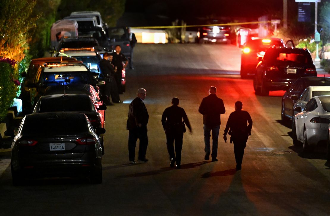 Police investigators walk down the street where Matthew Perry's house was located the night of his death in October 2023.