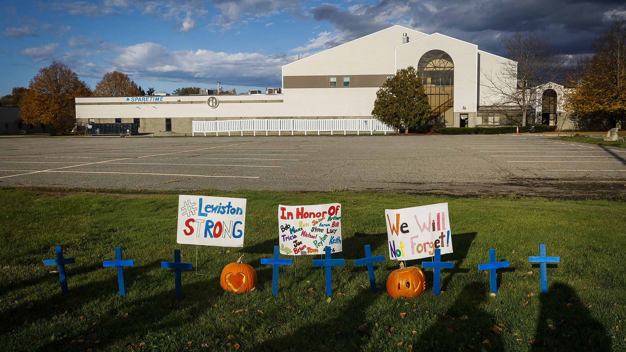 Homemade crosses and signs in front of Just-In-Time Recreation on October 28, 2023, honor the victims of the shootings in Lewiston, Maine.