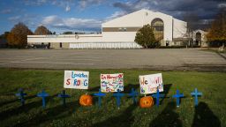 Homemade crosses and signs in front of Just-In-Time Recreation honor the victims of the shootings in Lewiston, Maine..