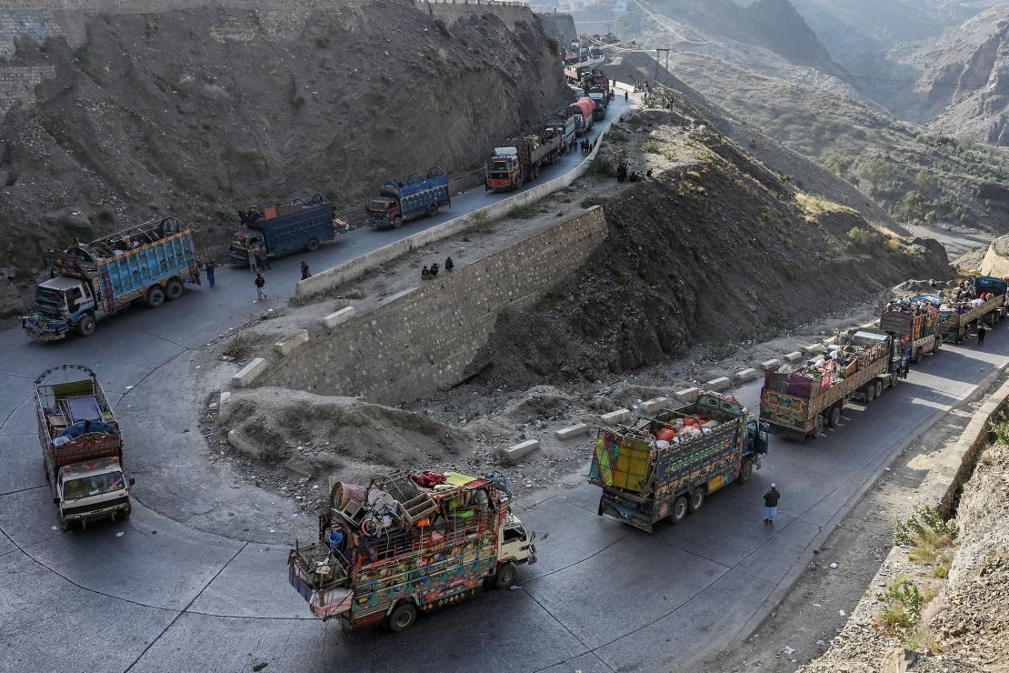 Trucks transporting Afghan refugees and their belongings are seen along a road heading toward the Pakistan-Afghanistan Torkham border on November 3, 2023.