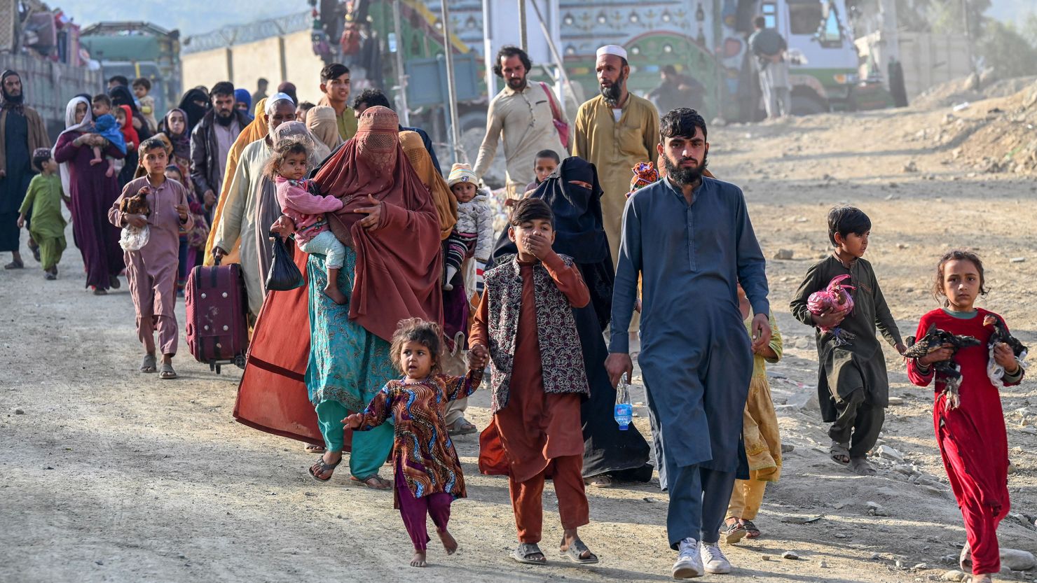 Afghan refugees in Pakistan walk toward the Pakistan-Afghanistan Torkham border on November 3, 2023, following Pakistan's decision to expel undocumented people from the country.