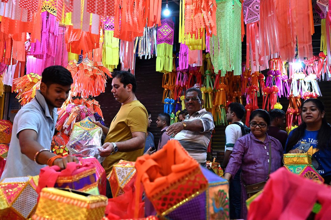 Customers buy paper lanterns and other decorative items at a shop in Mumbai ahead of Diwali in 2023.