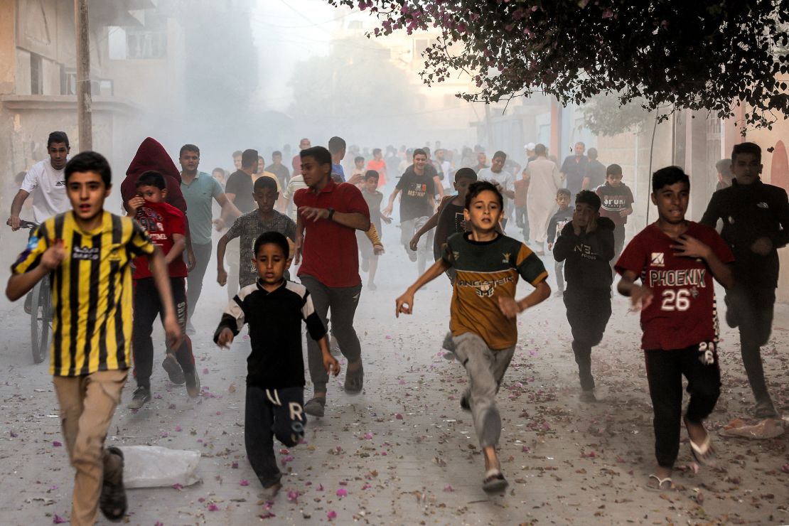 Palestinian children run as they flee from Israeli bombardment in Rafah, in southern Gaza, on November 6, 2023.