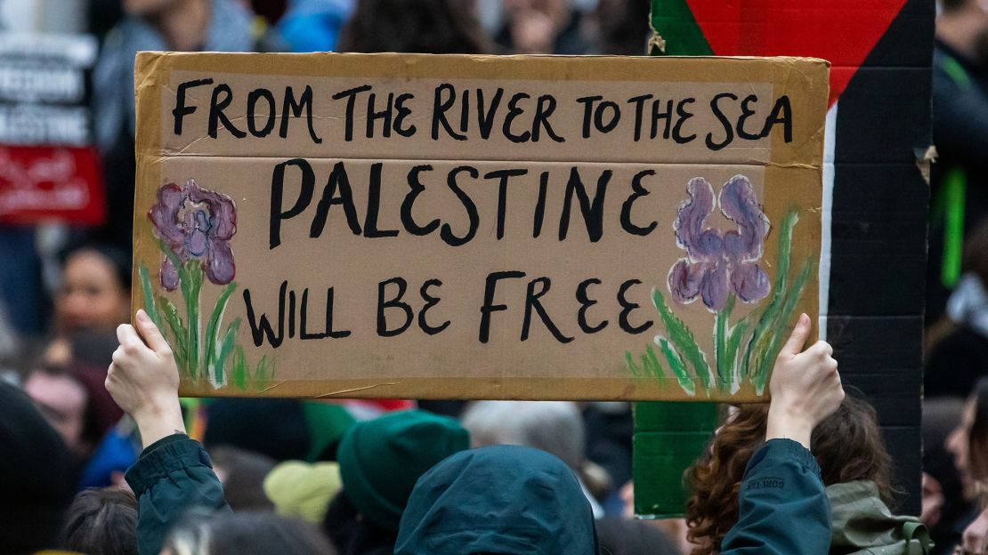 A pro-Palestinian activist holds up a sign during a sit-down protest inside London's Charing Cross railway station to call for an immediate ceasefire in Gaza, on 4 November 2023.