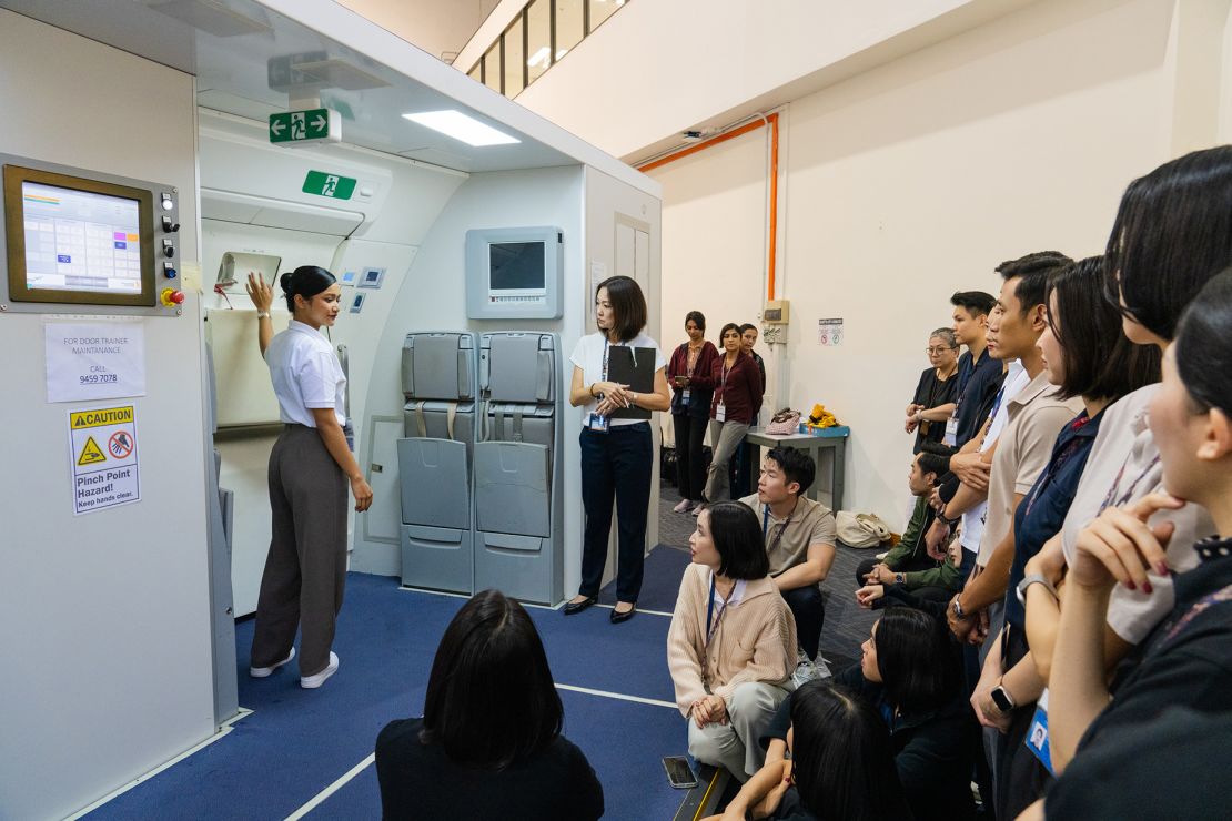 Cabin crew go through rigorous training. Pictured here: Singapore Airlines trainees at the company's training centre in Singapore.