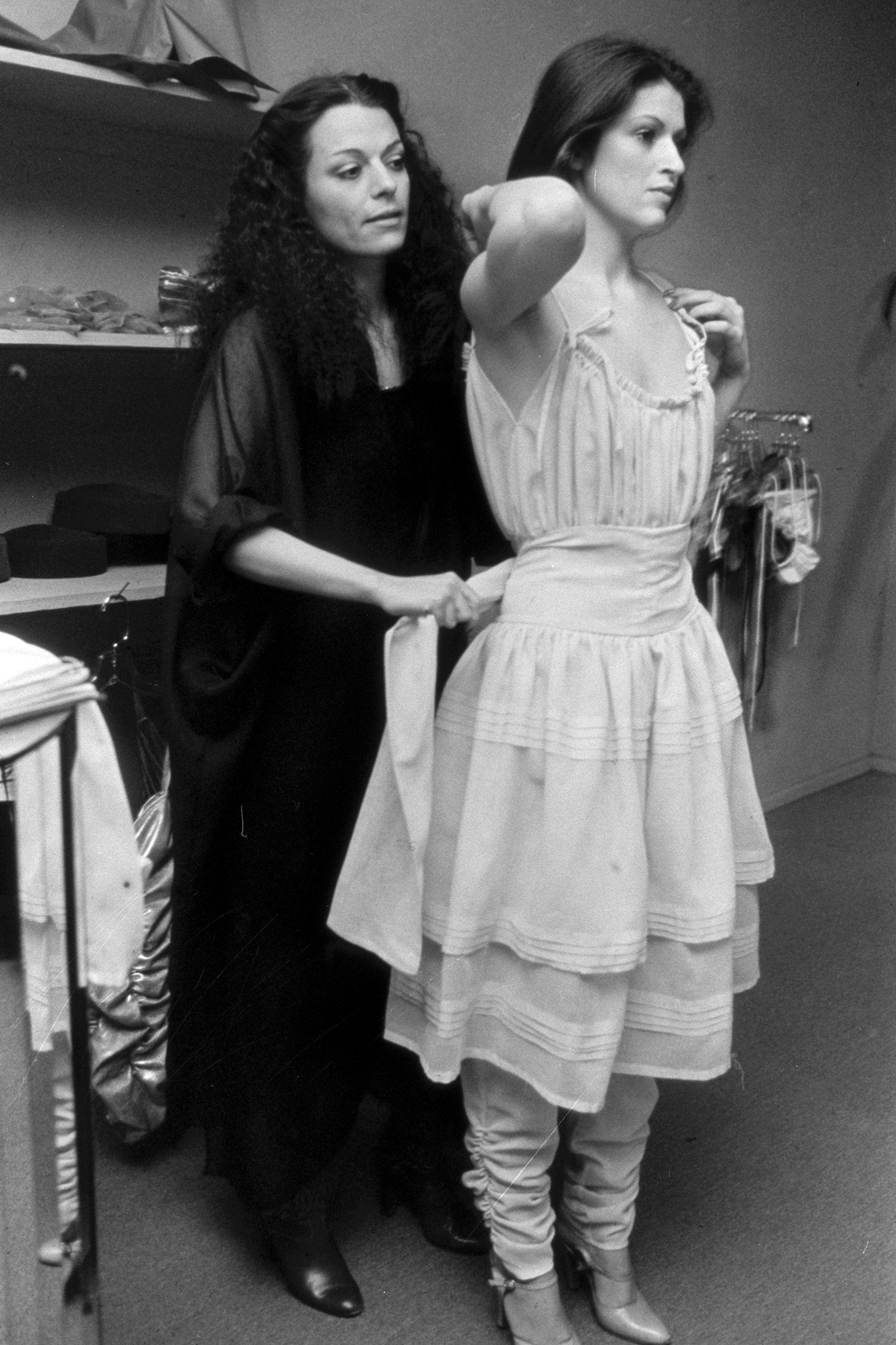 Norma Kamali styling a model at her New York boutique in 1977. The brand's archive forms a key part of their plans to embrace AI.