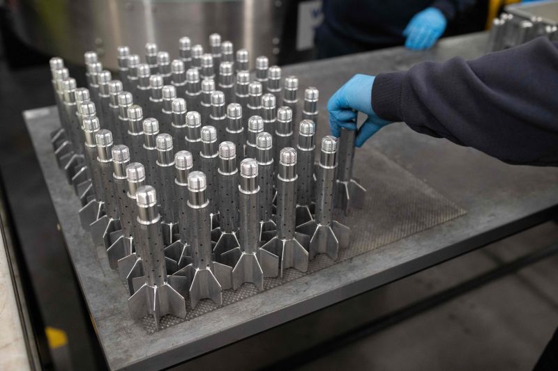 A BAE Systems employee works on High Explosive Mortar munitions at the company's factory near Newcastle upon Tyne, England, in November 2023.