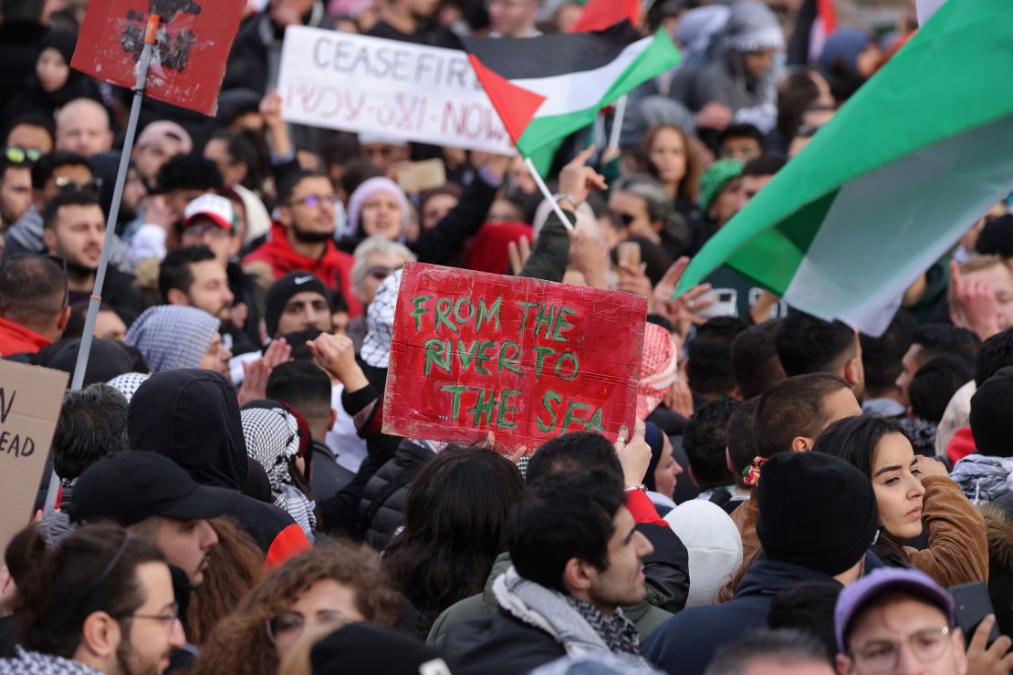 People, including one holding up a sign that reads: "From the River to the Sea", chant slogans under Palestinian flags during a "Freedom for Palestine" protest that drew thousands of participants on November 04, 2023 in Berlin, Germany.