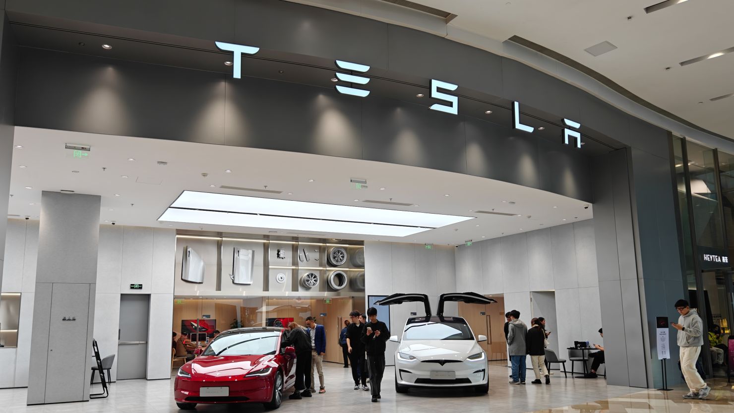 Customers shop at a Tesla new energy vehicle store in Shanghai, China