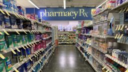 Merchandise aisle and Pharmacy Sign at Walgreens, Queens, New York.