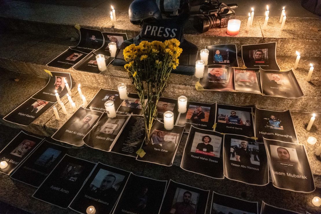 Flowers and candles are placed among pictures of journalists at a vigil in lower Manhattan on November 6, 2023, in New York City. The vigil is held to remember and celebrate the lives of journalists killed in recent fighting in Israel, Gaza and Lebanon.