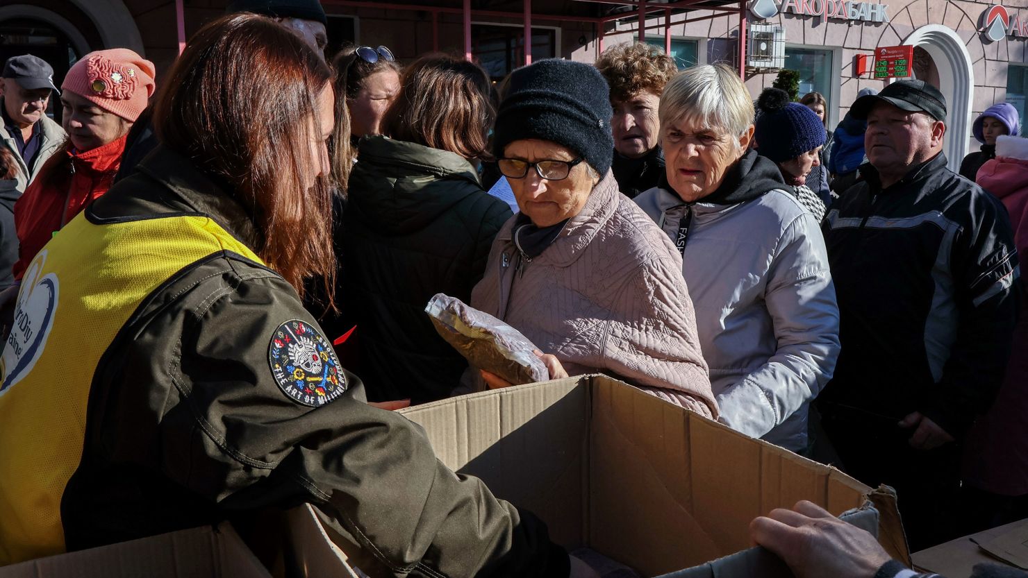 People receive humanitarian aid at a distribution point in Zaporizhzhia.