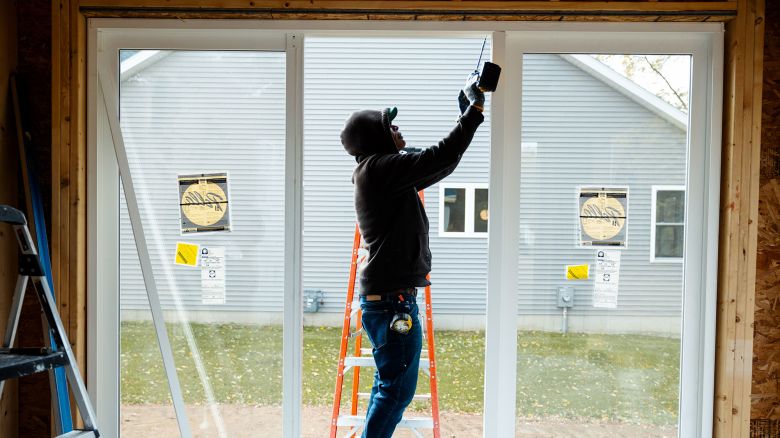 A worker uses a drill to install a window frame at a home under construction at the Cold Spring Barbera Homes subdivision in Loudonville, New York, US, on Wednesday Nov. 8, 2023. The National Association of Home Builders (NAHB) released housing market index figures on November 16.