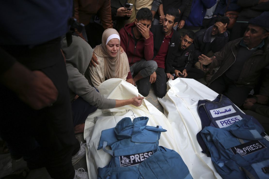 Journalists, relatives and friends pray over the body Journalists Sari Mansour and Hassouna Esleem after they were killed in an Israeli bombardment of Bureij camp in the central Gaza Strip on November 19, 2023.